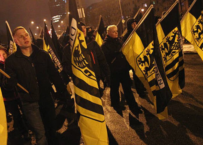 DRESDEN, GERMANY - FEBRUARY 13:  Neo-Nazis and their sympathizers march to commemorate the World War II firebombing of Dresden by Allied planes on February 13, 2012 in Dresden, Germany. Protesters attempted unsuccessfully to surround the expected 1,500 neo-Nazis with a human chain in order to prevent them from marching through the city in the annual event. Right-wing extremism is currently making national headlines in Germany due to the revelation that a pair of neo-Nazis claiming to be part of a group called the National Socialist Underground (NSU) murdered at least 10 immigrant small-business owners as well as a policewoman over a decade-long period, and that police investigations at the time were either botched or willfully aborted.  (Photo by Sean Gallup/Getty Images)