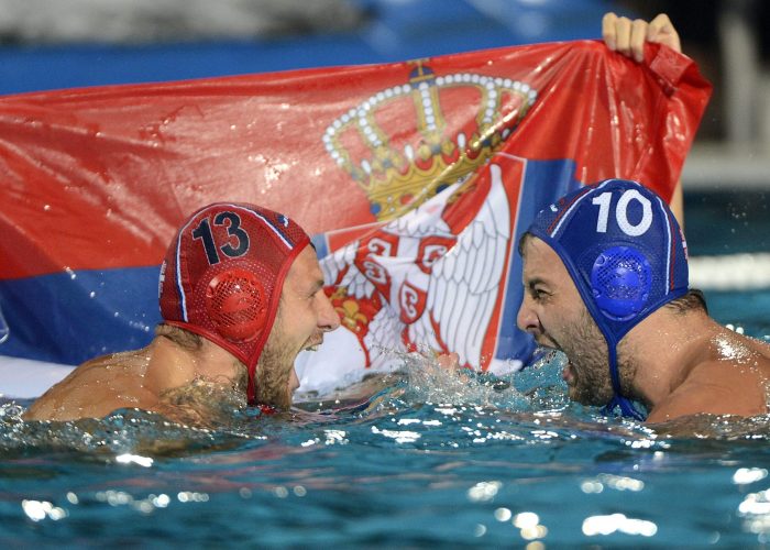 epa04333313 Branislav Mitrovic (L) and Filip Filipovic of Serbia celebrate with a Serbian flag after they defeated Hungary in the men's final of European Water Polo Championships in Hajos Alfred Swimming Pool in Budapest, Hungary, 27 July 2014.  EPA/Tamas Kovacs